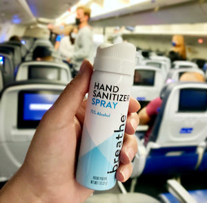 
                
                    Load image into Gallery viewer, holding breathe 1 oz hand sanitizer spray on plane
                
            